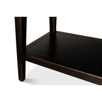 Lower shelf detail of ebonized display cabinet bookcase.