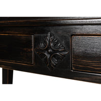 Close-up of carved motif on ebonized display cabinet.