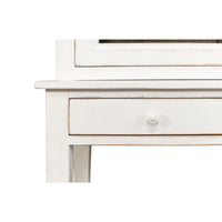 Close-up of drawer handle on white display cabinet.