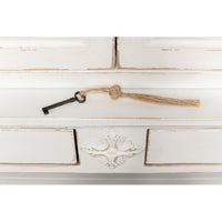 Key on cabinet lock with tassel detail.