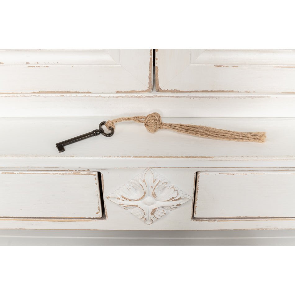 Key on cabinet lock with tassel detail.