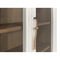 Close-up of cabinet door lock with tassel.