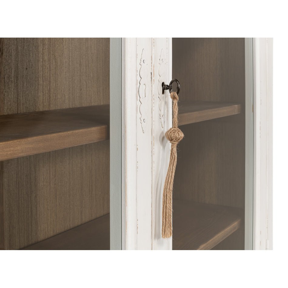 Close-up of cabinet door lock with tassel.