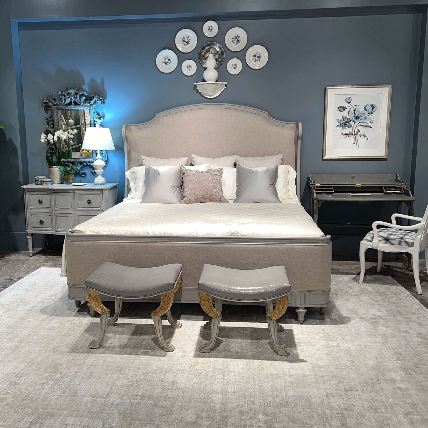 King size bed styled in a decorated bedroom setting.