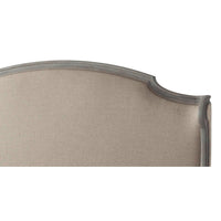 Close-up of headboard's detailed upholstery and frame.