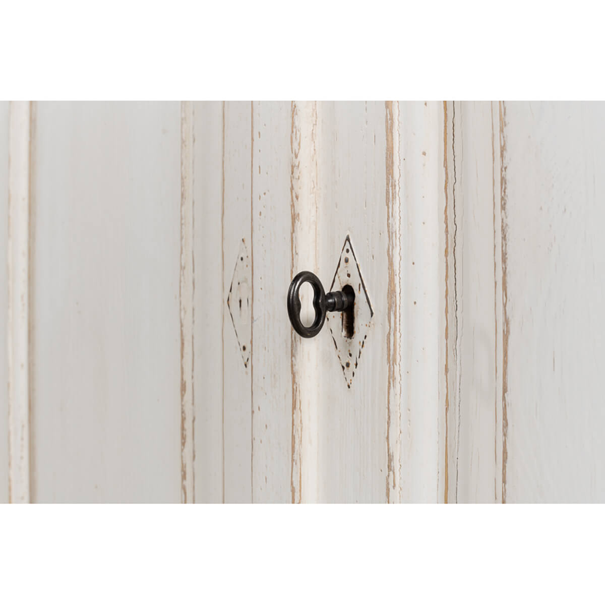 Keyhole detail on whitewash painted buffet door.