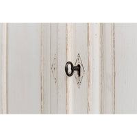 Keyhole detail on whitewash painted buffet door.