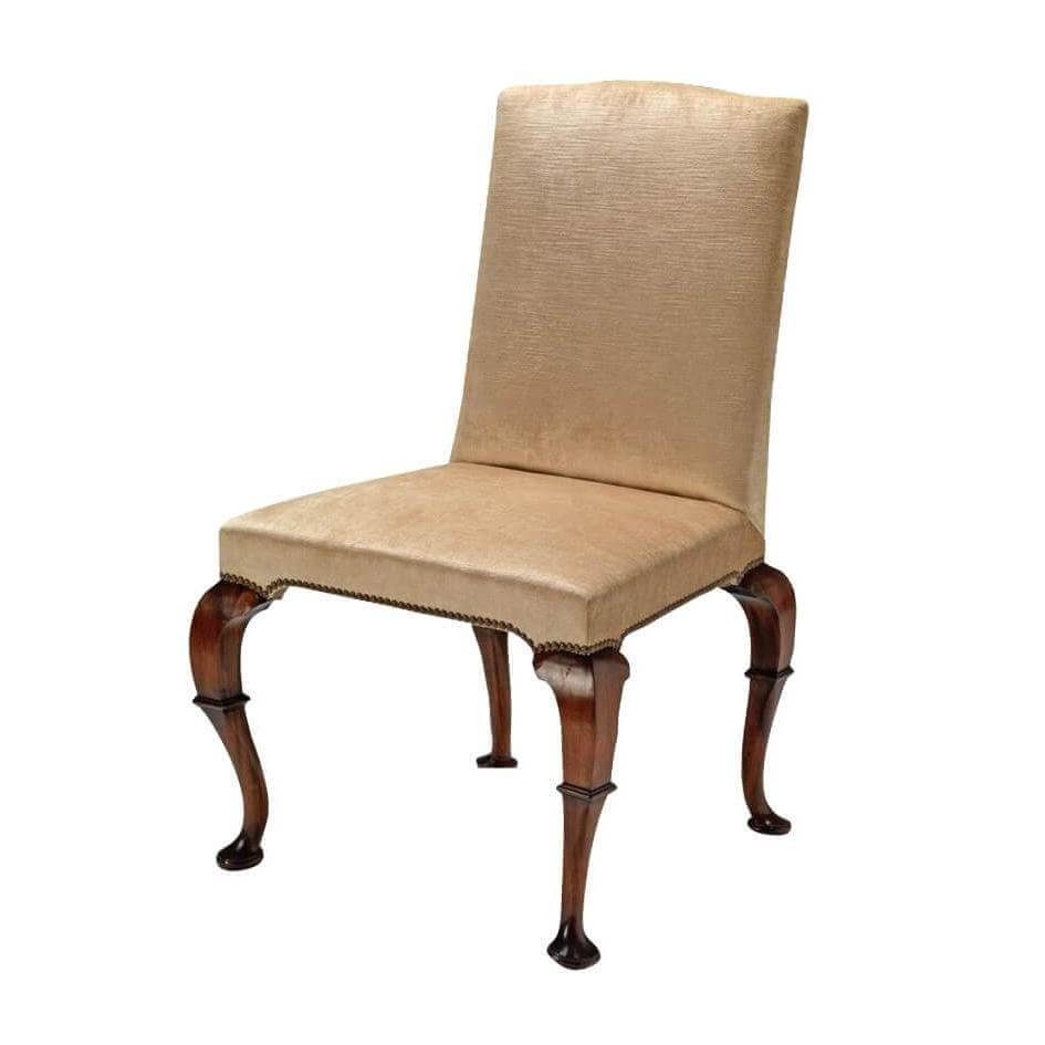 Elegant Queen Anne dining chair with wooden legs.