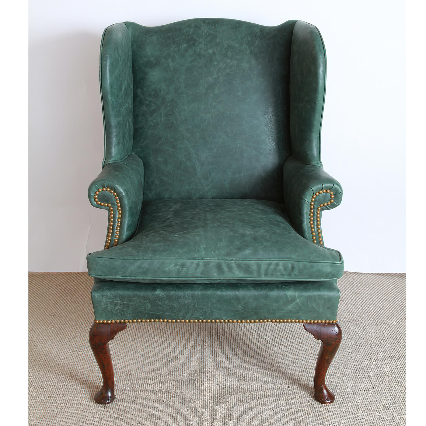 Front view of Queen Anne style leather wingchair.