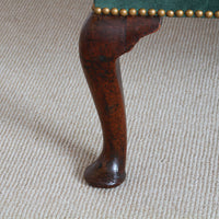Detailed view of wingchair leg with cabriole design.