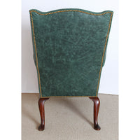 Back view of the green leather upholstered wingchair.