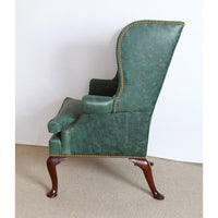 Side profile of green wingchair showing detailed construction.