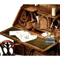 Queen Anne secretary bookcase desk area, writing materials displayed.