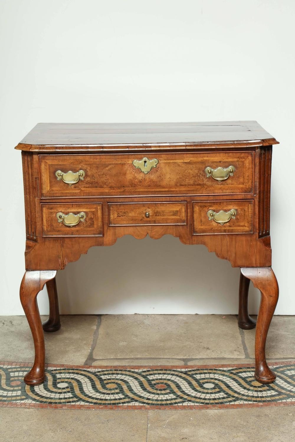 Queen Anne walnut lowboy, straight front view, intricate woodwork.