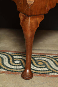 Close-up of front leg on Queen Anne walnut lowboy.