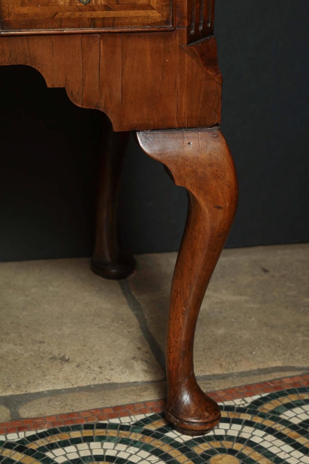 Detailed view of Queen Anne walnut lowboy leg design.