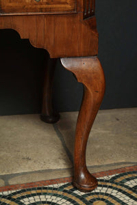 Detailed view of Queen Anne walnut lowboy leg design.