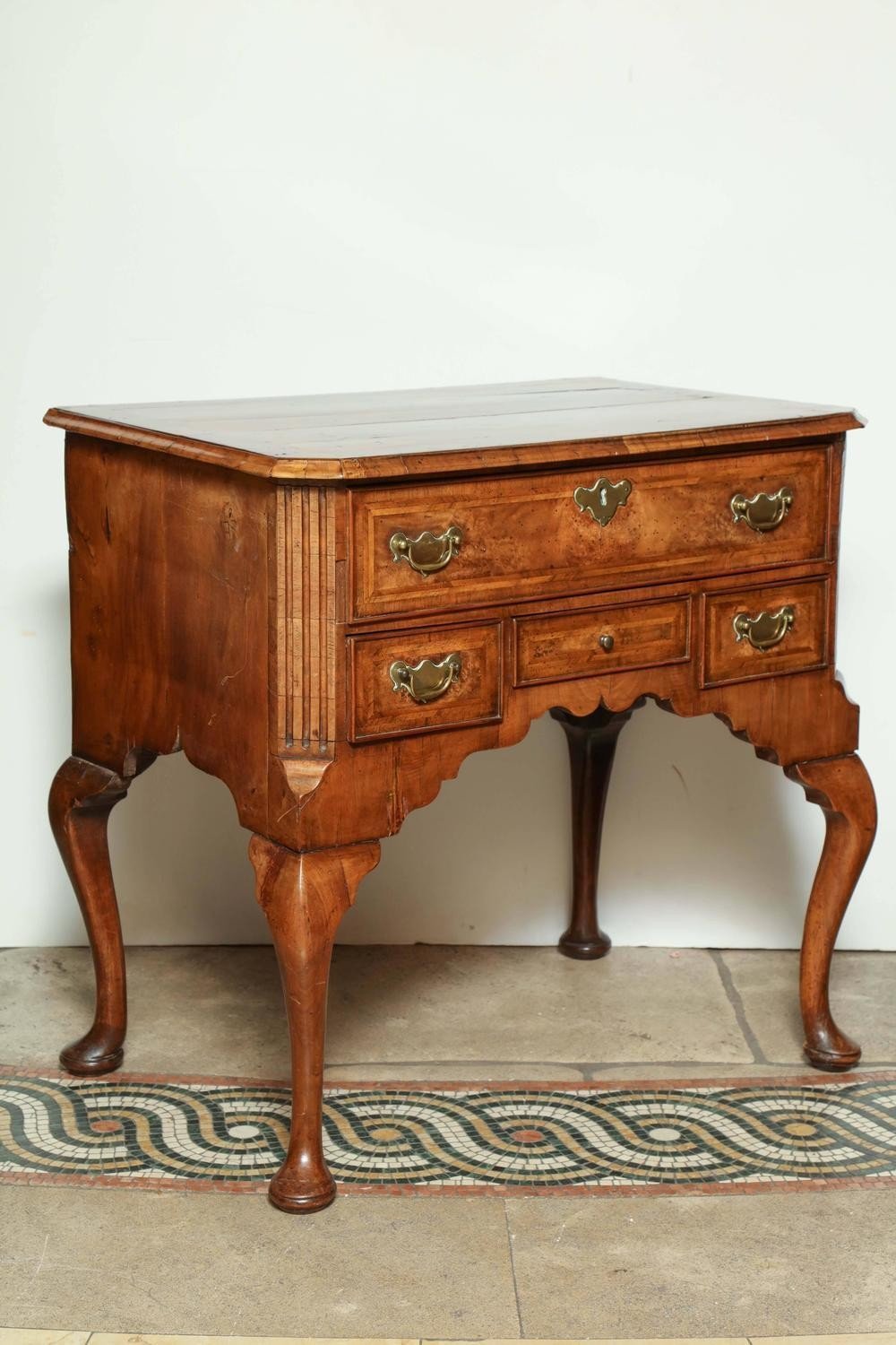 Front view of Queen Anne walnut lowboy, detailed craftsmanship.