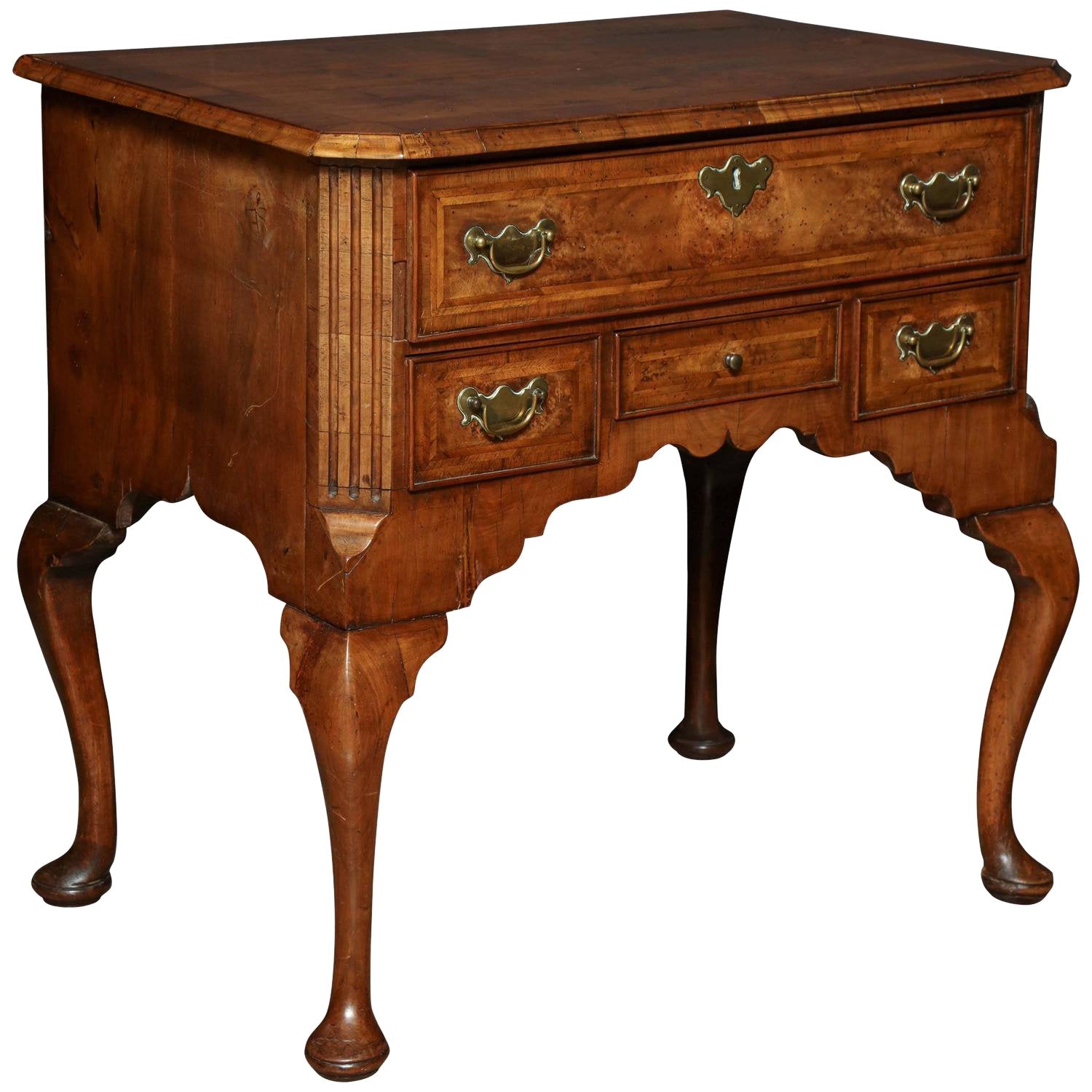 Queen Anne walnut lowboy with three drawers, angled view.