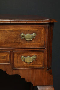 Close-up of brass handles on Queen Anne walnut lowboy.