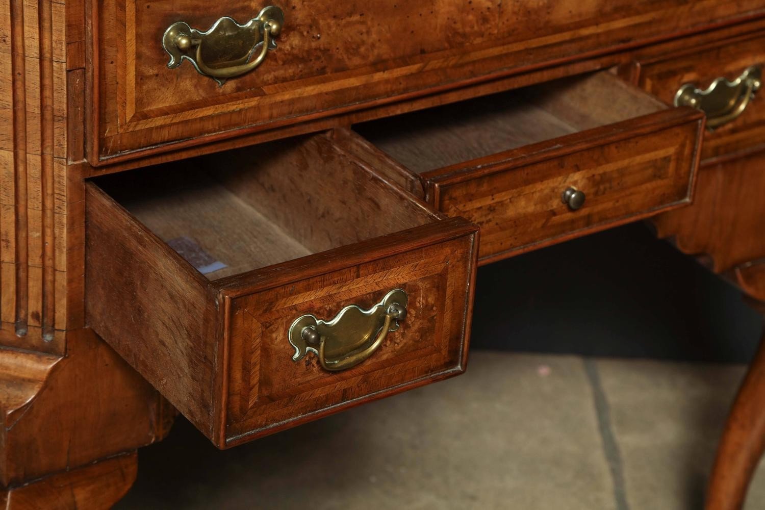 Two open drawers of Queen Anne walnut lowboy, interior details.