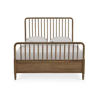 Wooden spindle bed frame, front view with pillows.