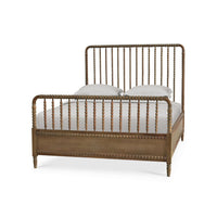 Wooden spindle bed frame, angled view with pillows.