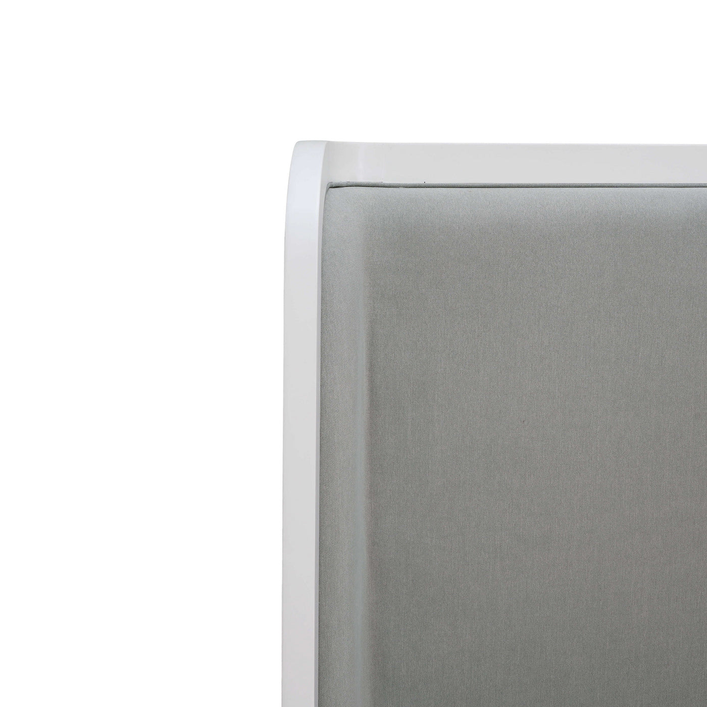 Headboard close-up, gray upholstery with white trim.