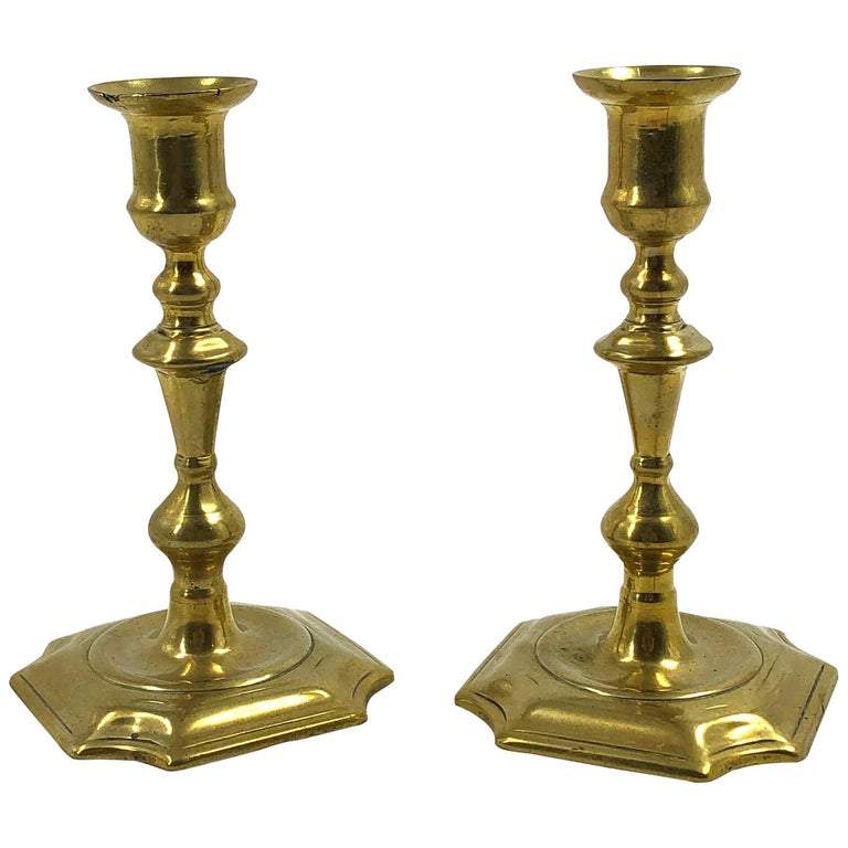 Pair of rare Queen Anne brass candlesticks, front view.
