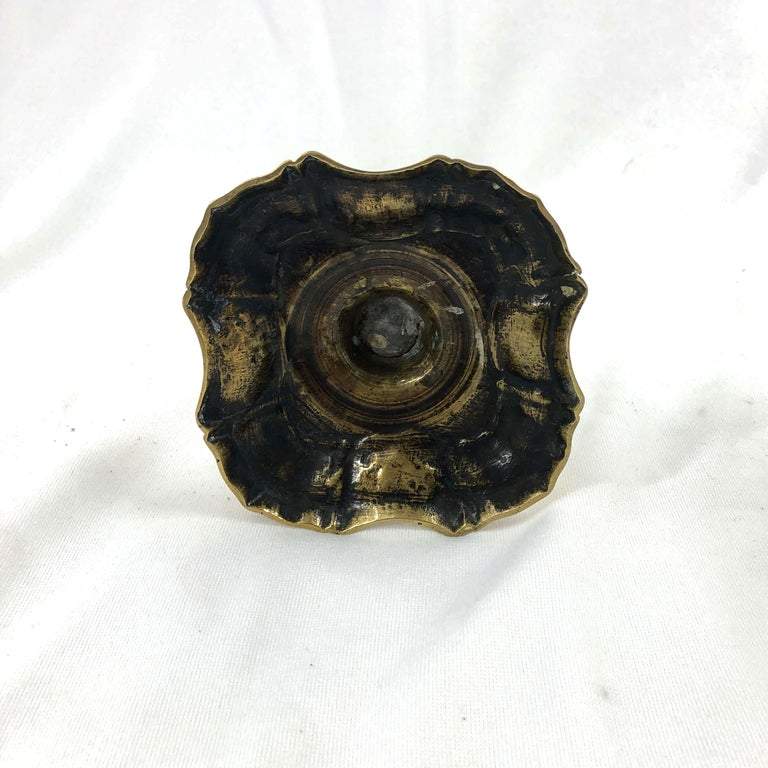 Bottom view of Queen Anne brass candlestick, antique finish.