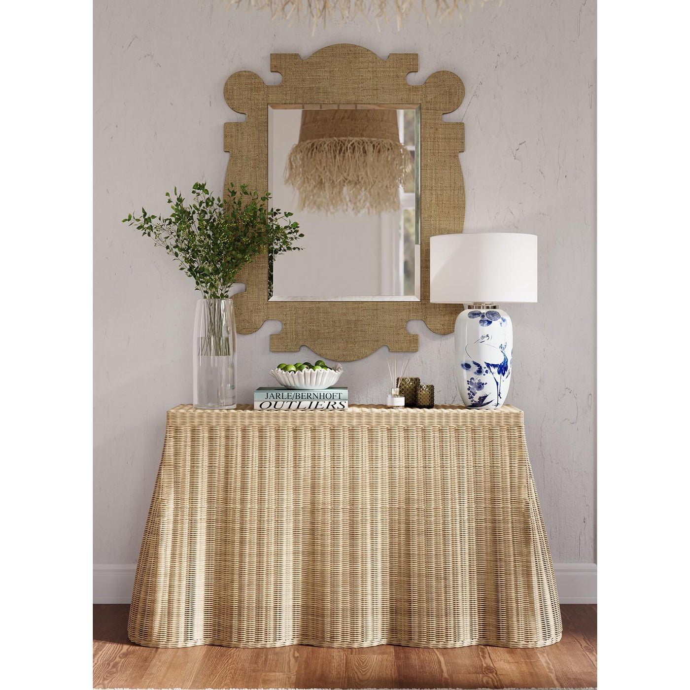 Rattan console table styled with decor in living room.