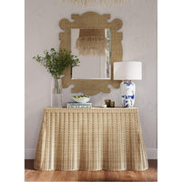 Rattan console table styled with decor in living room.