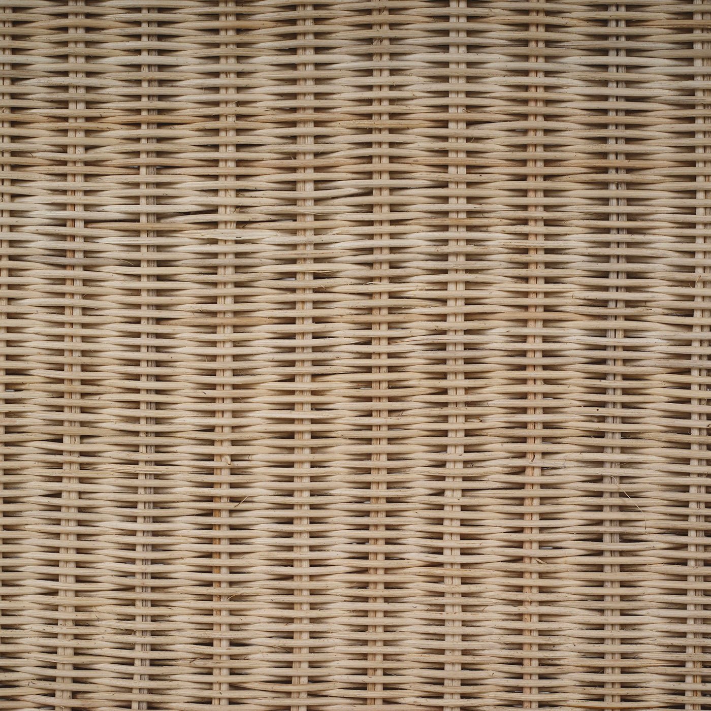 Detailed texture of rattan console table surface.