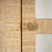 Close-up of rattan cabinet door knob and texture.