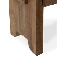Close-up of the reclaimed wood bench end leg showing worn grain and the curved corners of its bottom notch