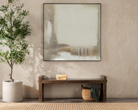 Reclaimed wood bench with raised ends beneath abstract wall art, with books above and a basket below