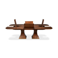 Rectangular walnut table opening with leaves extended.