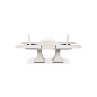 Dining table with extended leaves and support mechanism visible.