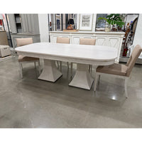 Dining table with chairs in a showroom setting.