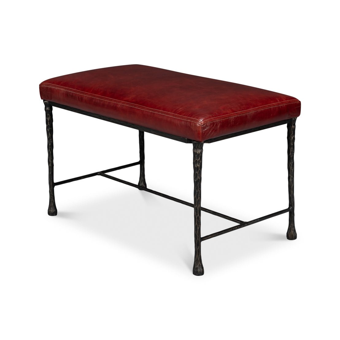 Side angle view of rustic bench, red leather seat.