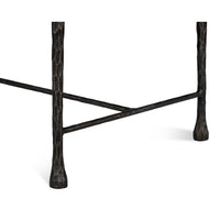 Close-up of iron leg details on rustic small bench.