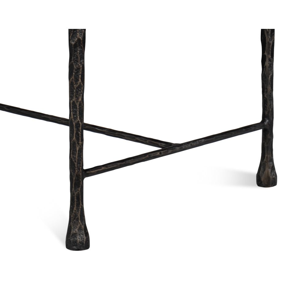 Close-up of iron leg details on rustic small bench.