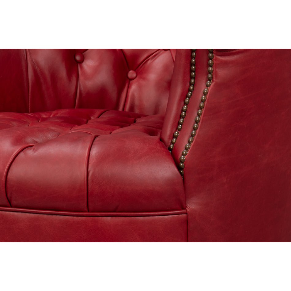 Red barrel chair seat and nailhead trim detail.
