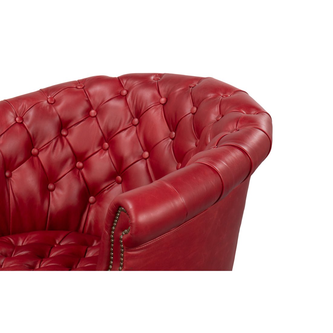 Red leather barrel back chair button-tufted armrest.