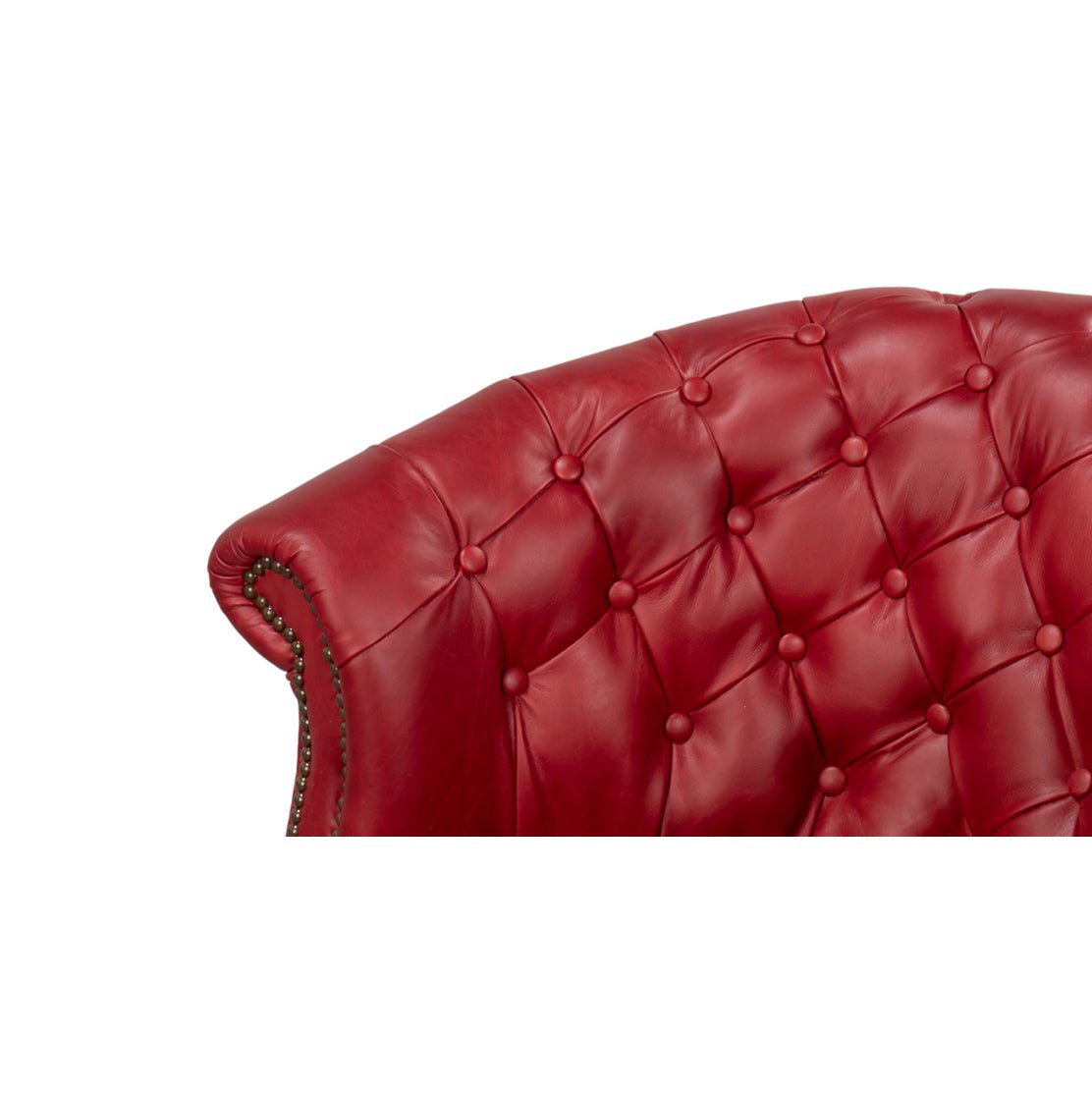 Button-tufted backrest detail on red barrel chair.