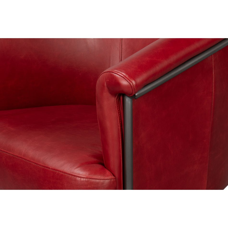 Close-up arm detail red leather tub chair.