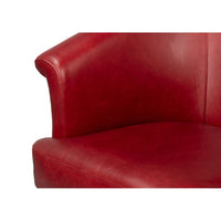 Red leather tub chair seat corner close-up.