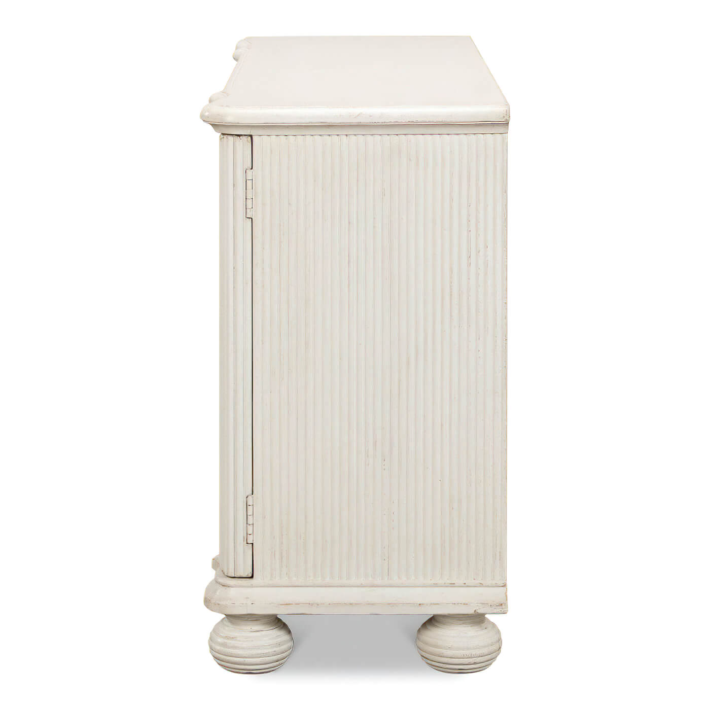 Side view of reeded antique white cabinet, ribbed design.