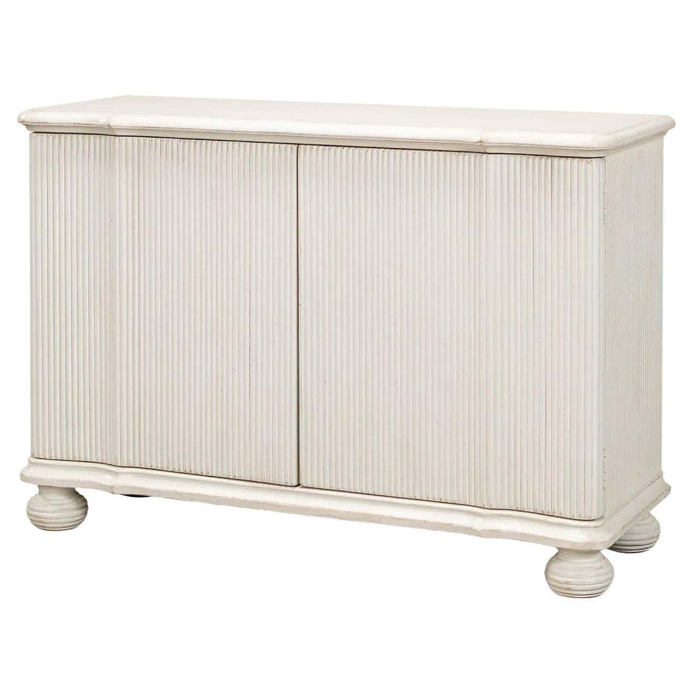 Reeded antique white cabinet angled view with closed doors.