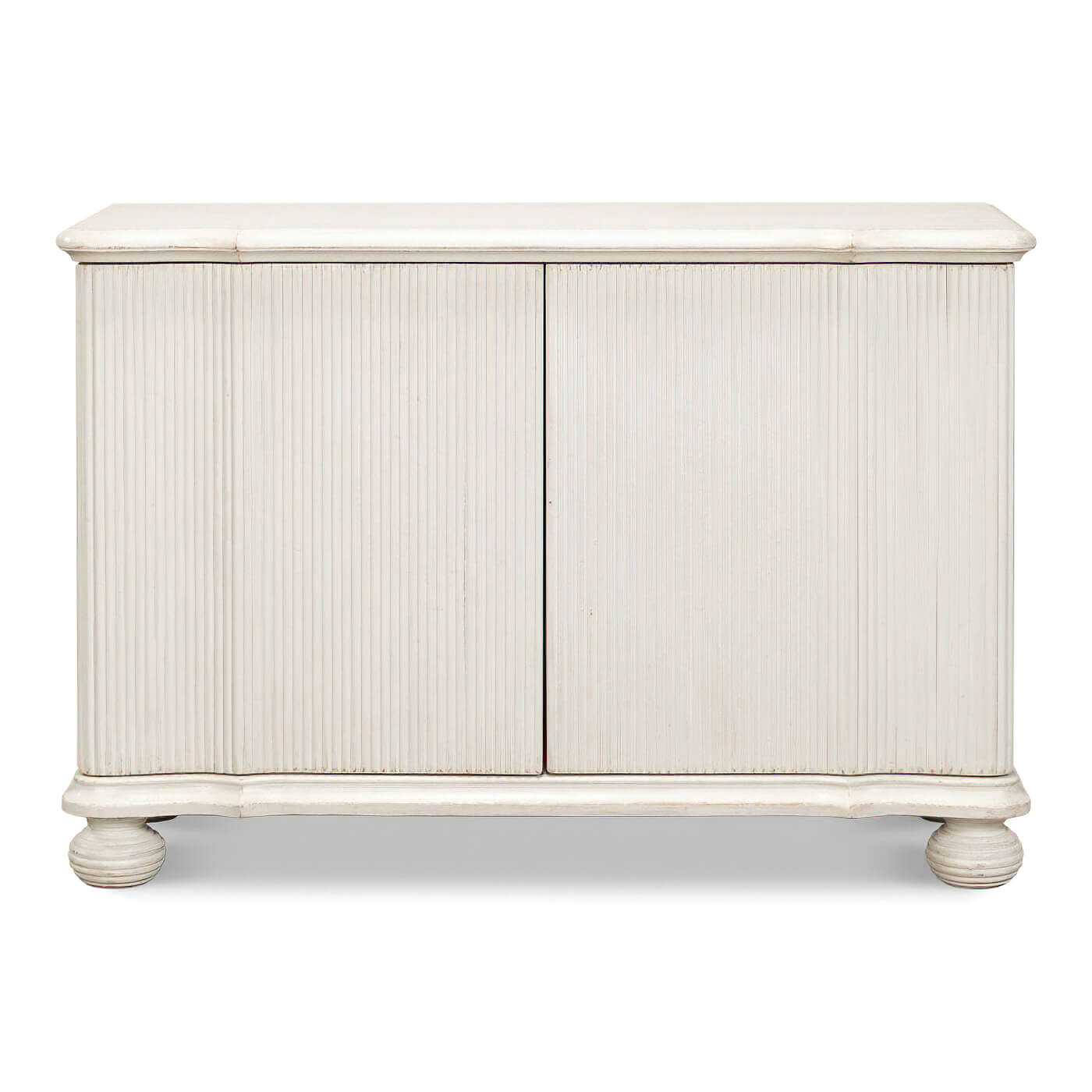 Front view of reeded antique white cabinet, closed doors.